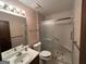 Updated bathroom with a glass-enclosed shower, modern fixtures, vanity, and decorative wallpaper at 1499 Carriage Ln, Jonesboro, GA 30238