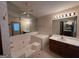 Spacious bathroom featuring a large soaking tub with tiled surround and a vanity with ample counter space at 1499 Carriage Ln, Jonesboro, GA 30238