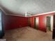 Spacious primary bedroom with red walls, ceiling fan, neutral carpeting, and dual closets at 1499 Carriage Ln, Jonesboro, GA 30238