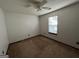 Bedroom with neutral carpet, ample natural light, ceiling fan, and electrical outlets at 1499 Carriage Ln, Jonesboro, GA 30238