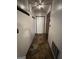 Hallway featuring stone tile flooring, coat rack, decorative light fixture, and access to other rooms at 1499 Carriage Ln, Jonesboro, GA 30238
