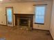 Cozy living room featuring a stone fireplace, neutral carpet, and natural light from a nearby window at 1499 Carriage Ln, Jonesboro, GA 30238