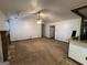 Spacious living area with a fireplace, ceiling fan, and open access to the dining and kitchen areas at 1499 Carriage Ln, Jonesboro, GA 30238