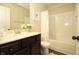 Bathroom features a bathtub with shower, vanity with a sink, and decorative floral arrangement at 316 Trulove Lane Lot 35 # 35, Locust Grove, GA 30248