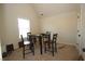 Carpeted dining room features an ample table, chairs, and natural light from the window at 316 Trulove Lane Lot 35 # 35, Locust Grove, GA 30248