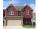 Charming two-story home with brick and red siding, featuring an attached two-car garage at 316 Trulove Lane Lot 35 # 35, Locust Grove, GA 30248