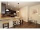 Open kitchen with granite countertops, dark cabinets, stainless appliances, and barstool seating at 316 Trulove Lane Lot 35 # 35, Locust Grove, GA 30248