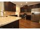 Modern kitchen with stainless steel appliances, granite countertops, and dark wood cabinetry at 316 Trulove Lane Lot 35 # 35, Locust Grove, GA 30248