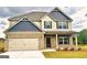 Inviting two-story home with a brick facade and a well-maintained lawn at 328 Trulove Lane Lot 32 # 32, Locust Grove, GA 30248
