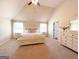 Bright main bedroom featuring vaulted ceilings, a ceiling fan, and large windows for ample natural light at 328 Trulove Lane Lot 32 # 32, Locust Grove, GA 30248