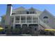 Charming home featuring a spacious, covered back porch and a well-maintained backyard with lush landscaping at 135 Danube Trl, Stockbridge, GA 30281