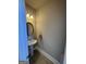 Half bathroom featuring a pedestal sink, decorative mirror, and tiled flooring at 135 Danube Trl, Stockbridge, GA 30281