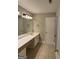 Bathroom features tiled floors, an expansive vanity area, and a white paneled door at 135 Danube Trl, Stockbridge, GA 30281