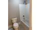 Neutral bathroom featuring a tiled shower over the tub, toilet, and neutral walls at 135 Danube Trl, Stockbridge, GA 30281