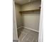 Walk-in closet featuring neutral walls, carpet flooring, and a wooden shelf with a rod at 135 Danube Trl, Stockbridge, GA 30281