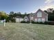 Beautiful two-story brick home featuring a well-manicured lawn and lush landscaping at 135 Danube Trl, Stockbridge, GA 30281