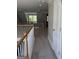 Upstairs hallway featuring carpet and banister overlooking the first floor at 135 Danube Trl, Stockbridge, GA 30281