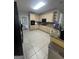 Well-equipped kitchen with tiled floor, granite counters, light wood cabinets, and modern appliances at 135 Danube Trl, Stockbridge, GA 30281