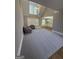 Bright living room with carpet, ceiling fan, and large windows overlooking the backyard at 135 Danube Trl, Stockbridge, GA 30281