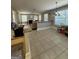 Open concept living room with a fireplace, large windows, and bar seating in the kitchen at 135 Danube Trl, Stockbridge, GA 30281