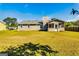 Spacious backyard featuring a well-maintained lawn and covered porch area at 2582 Rosecommons Dr, Hampton, GA 30228