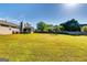 Expansive backyard with lush green grass, mature trees, and a charming screened-in porch at 2582 Rosecommons Dr, Hampton, GA 30228