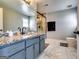 Updated bathroom with a granite countertop, blue vanity, frameless shower, and modern fixtures at 2582 Rosecommons Dr, Hampton, GA 30228