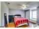 Comfortable bedroom with hardwood floors, ceiling fan, and bright window seat at 2582 Rosecommons Dr, Hampton, GA 30228
