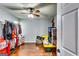 Bedroom with hardwood floors, a ceiling fan, natural light, and closet space for storage at 2582 Rosecommons Dr, Hampton, GA 30228