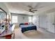 Bright bedroom featuring neutral walls, a ceiling fan, and a comfortable bed with ample natural light at 2582 Rosecommons Dr, Hampton, GA 30228