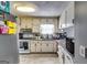 Functional kitchen featuring white cabinets, granite countertops, modern appliances, and updated tile flooring at 2582 Rosecommons Dr, Hampton, GA 30228