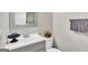 Compact bathroom with a framed mirror, decorative accents, and white fixtures at 2998 Kenville Ln, Decatur, GA 30034