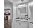 Bathroom featuring a white vanity with marble countertop and decorative mirror at 2998 Kenville Ln, Decatur, GA 30034