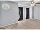 Large carpeted bedroom with a ceiling fan, featuring an octagonal window and curtains at 2998 Kenville Ln, Decatur, GA 30034