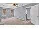 Spacious bedroom with ceiling fan, neutral carpet, and natural light from two windows at 2998 Kenville Ln, Decatur, GA 30034