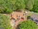 An aerial view reveals a charming residence with a brick facade and an expansive driveway at 2040 Elm Grove Ln, Hampton, GA 30228