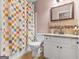 This bathroom includes a tiled shower, granite countertops, and a sink with storage at 2040 Elm Grove Ln, Hampton, GA 30228