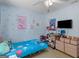 A charming bedroom is decorated with cartoon character motifs and light blue paint at 2040 Elm Grove Ln, Hampton, GA 30228
