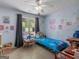 This cute bedroom is decorated with unique, colorful patterns and plenty of natural light at 2040 Elm Grove Ln, Hampton, GA 30228