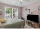 A cozy bedroom includes a large window and a flat screen television for entertainment at 2040 Elm Grove Ln, Hampton, GA 30228
