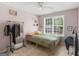 This bedroom offers a bright view from the large window with a ceiling fan at 2040 Elm Grove Ln, Hampton, GA 30228