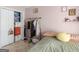 A casual bedroom is furnished with a bed, clothes rack, and a closet with open doors at 2040 Elm Grove Ln, Hampton, GA 30228
