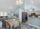 Dining area featuring chandelier lighting, modern decor, access to kitchen, and seating area at 2040 Elm Grove Ln, Hampton, GA 30228
