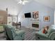 Bright living room with vaulted ceilings, fireplace, television, and comfortable seating with luxury vinyl plank floors at 2040 Elm Grove Ln, Hampton, GA 30228