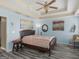 A bedroom featuring a ceiling fan and light blue colored walls and wood flooring at 2040 Elm Grove Ln, Hampton, GA 30228