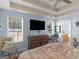 The main bedroom featuring tray ceilings, wood flooring and natural light through the windows at 2040 Elm Grove Ln, Hampton, GA 30228
