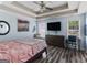 A primary bedroom boasts wood flooring, a ceiling fan, and two large windows at 2040 Elm Grove Ln, Hampton, GA 30228