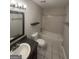 Bathroom features a single sink vanity, framed mirror, and light tile around the tub at 1232 Memorial Se Dr, Atlanta, GA 30316