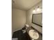 A half bathroom features a modern sink and vanity with a large mirror and modern lighting at 1232 Memorial Se Dr, Atlanta, GA 30316