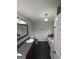 Bathroom features a single sink vanity, framed mirror, and dark tile floors at 1232 Memorial Se Dr, Atlanta, GA 30316